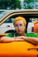 Photo by Abiy Fikru: https://www.pexels.com/photo/a-woman-with-dyed-orange-hair-sitting-in-an-orange-car-26583625/